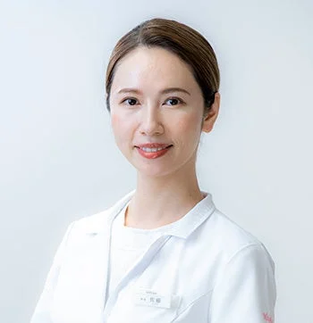 白衣を着て笑顔で正面を見ている女性のポートレート